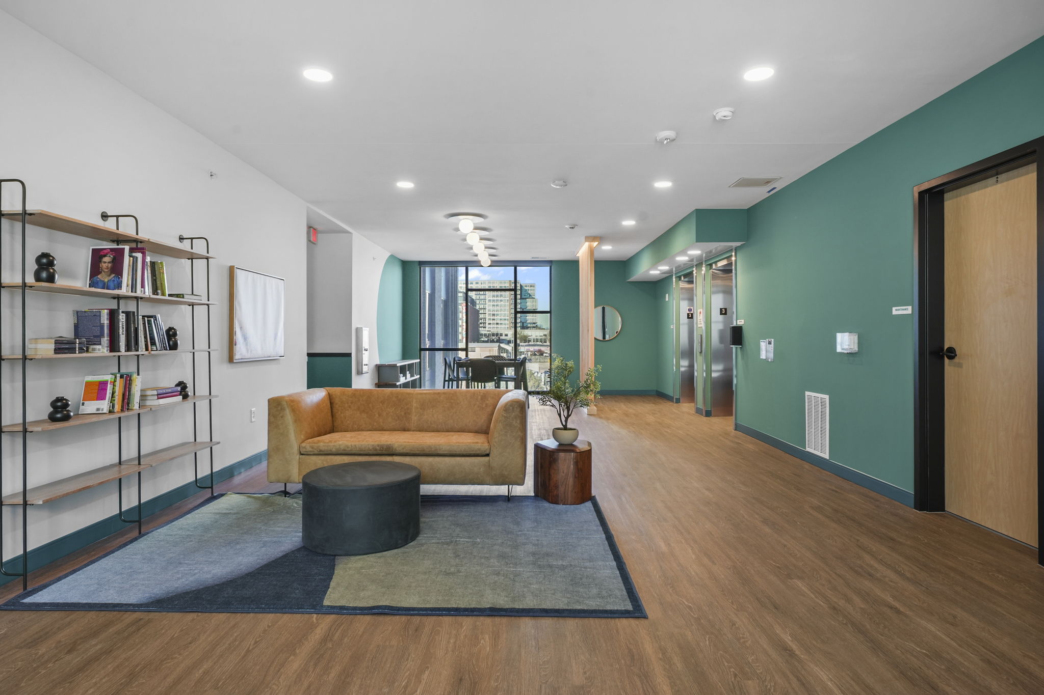 The Irwin den featuring comfortable seating and space for casual resident gatherings