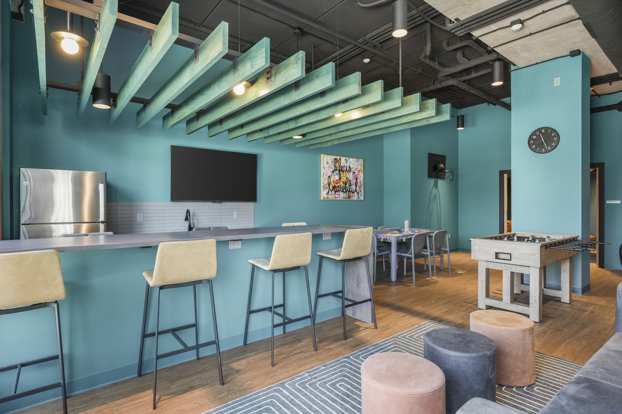 The Irwin lounge interior with modern furnishings, kitchen space, and areas for residents to connect