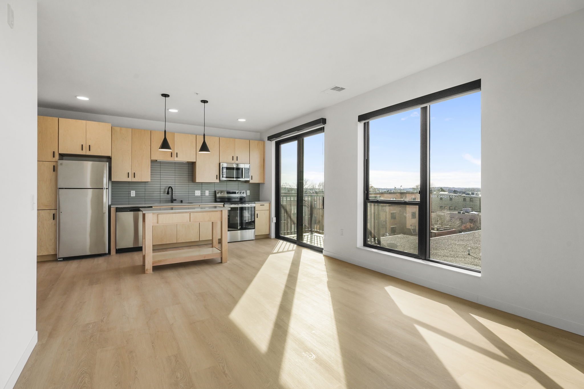 The Irwin apartment kitchen with modern cabinetry, countertops, and full appliance package