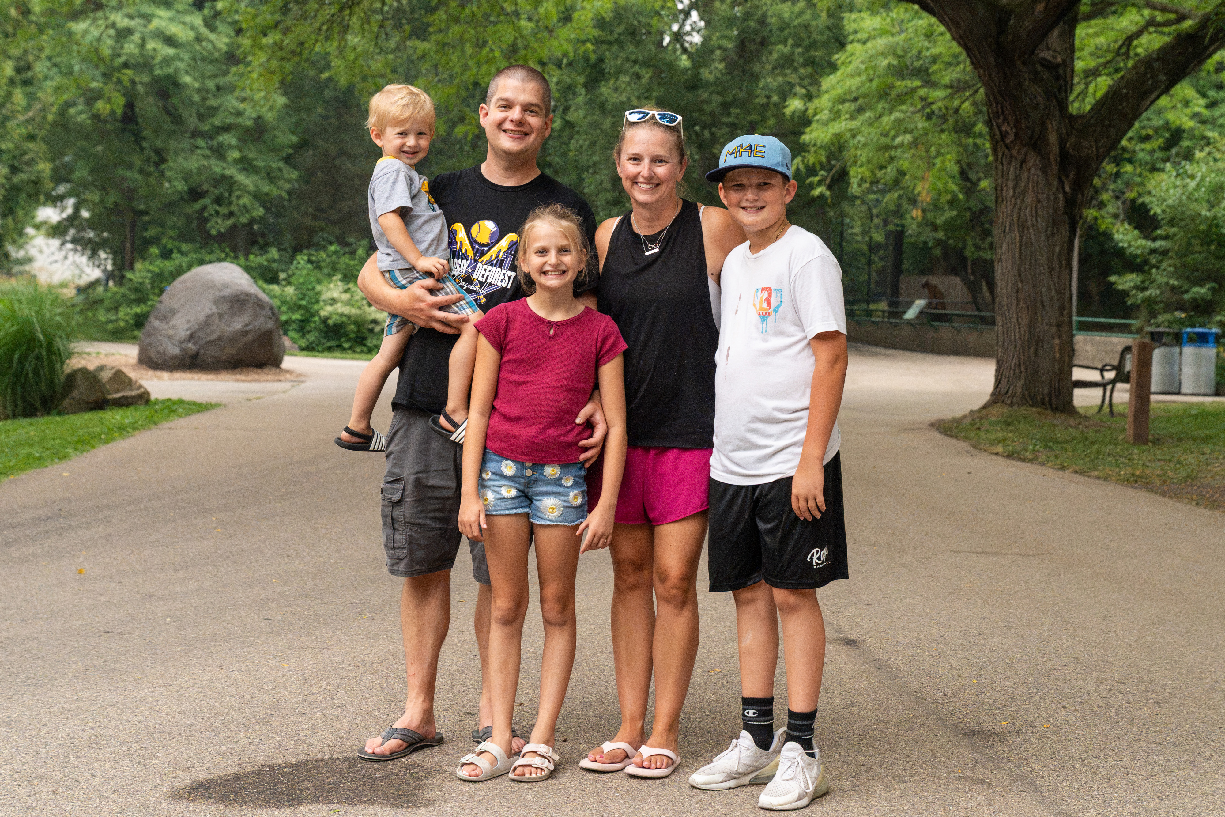An Urban Land Interests employee and family members posing together during the annual company picnic at Henry Vilas Zoo