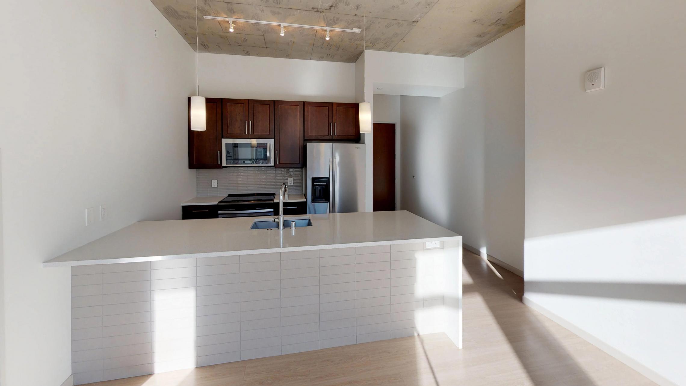 Pressman-211-Apartment-One-Bedroom-Luxury-Modern-Upscale-Downtown-Capitol-Concrete-Madison-Kitchen-Island-Living-Space-Sunny-Natural-Light