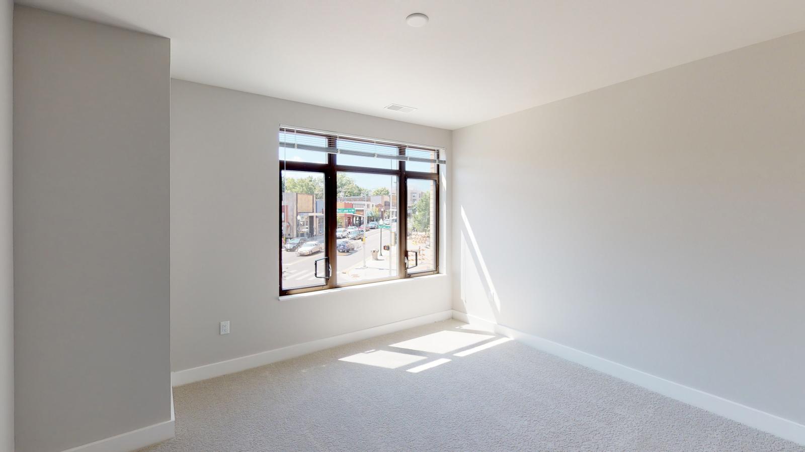 Spacious two-bedroom plus den apartment at 1722 Monroe Apartments in Madison with an open-concept layout and abundant natural light.