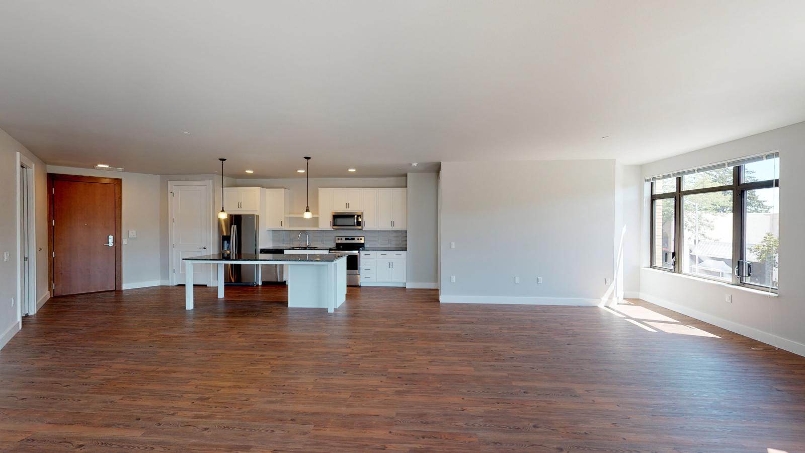 Stylish two-bedroom plus den apartment at 1722 Monroe Apartments in Madison featuring a bright living space and modern kitchen.