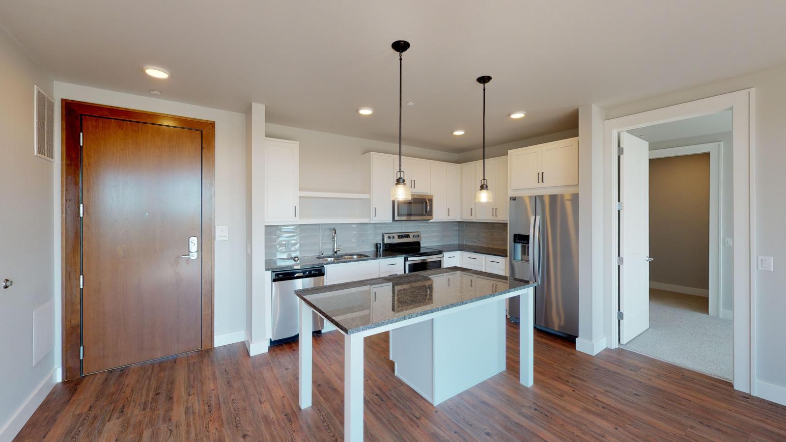 Contemporary two-bedroom apartment at 1722 Monroe Apartments in Madison with stylish cabinetry and stainless steel appliances.