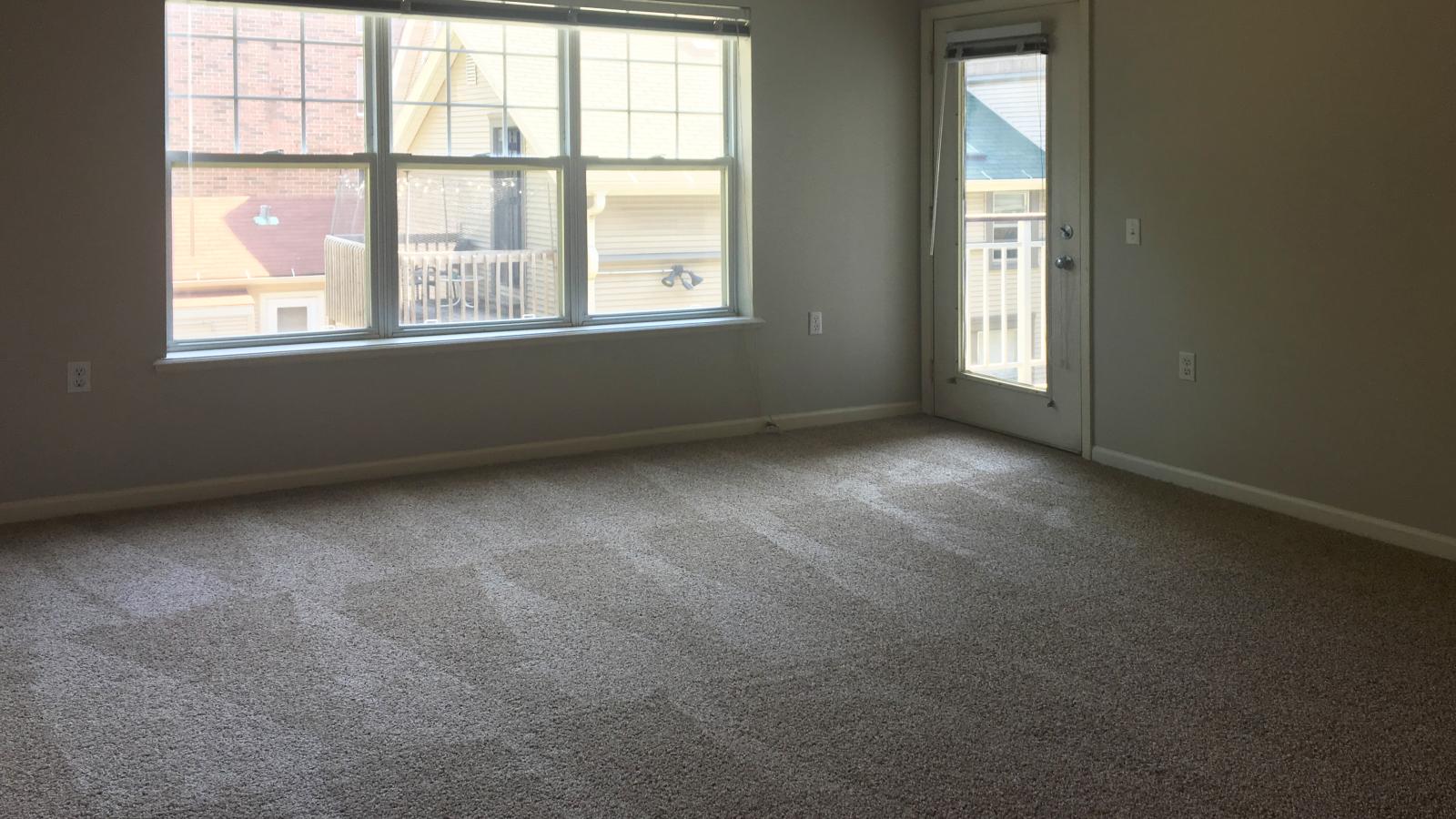 Cozy living room with soft finishes and private balcony at Wilson Bay