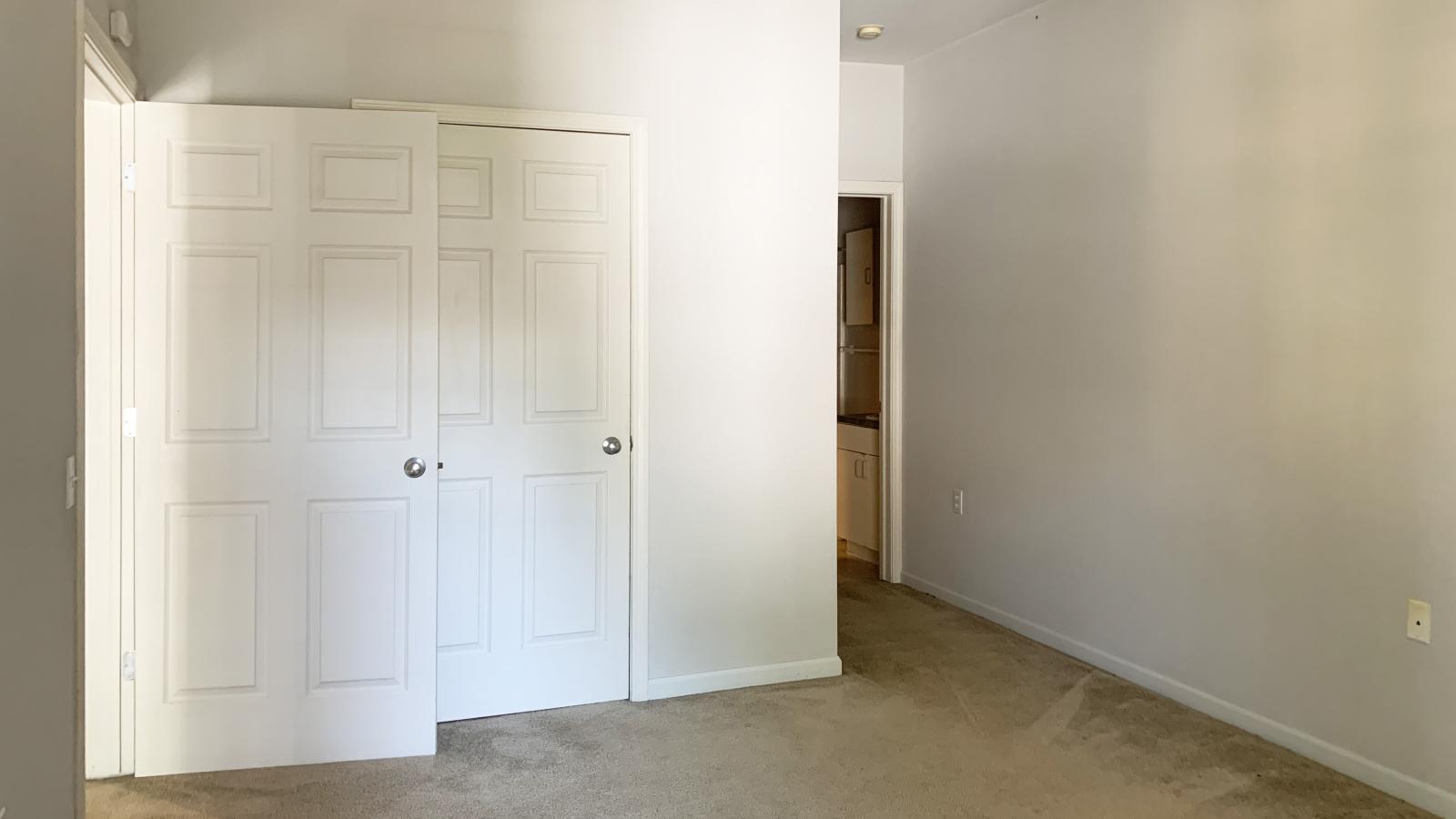 Spacious bedroom with a large closet and neutral finishes at Wilson Bay Apartments