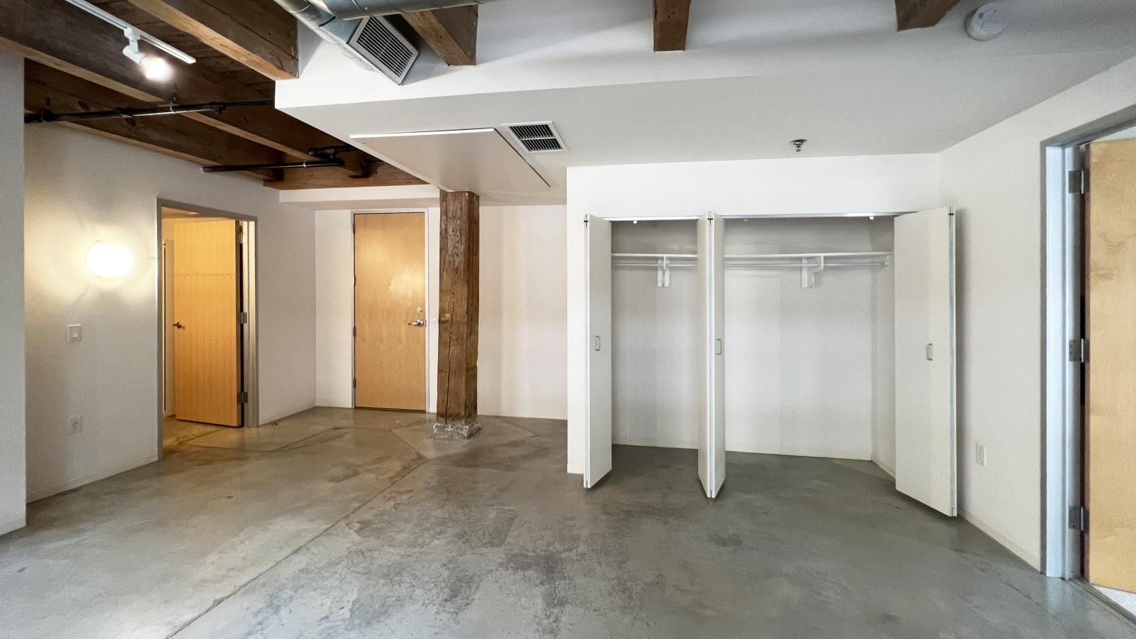 Historic one-bedroom with original timber beams and industrial-style loft features at Tobacco Lofts