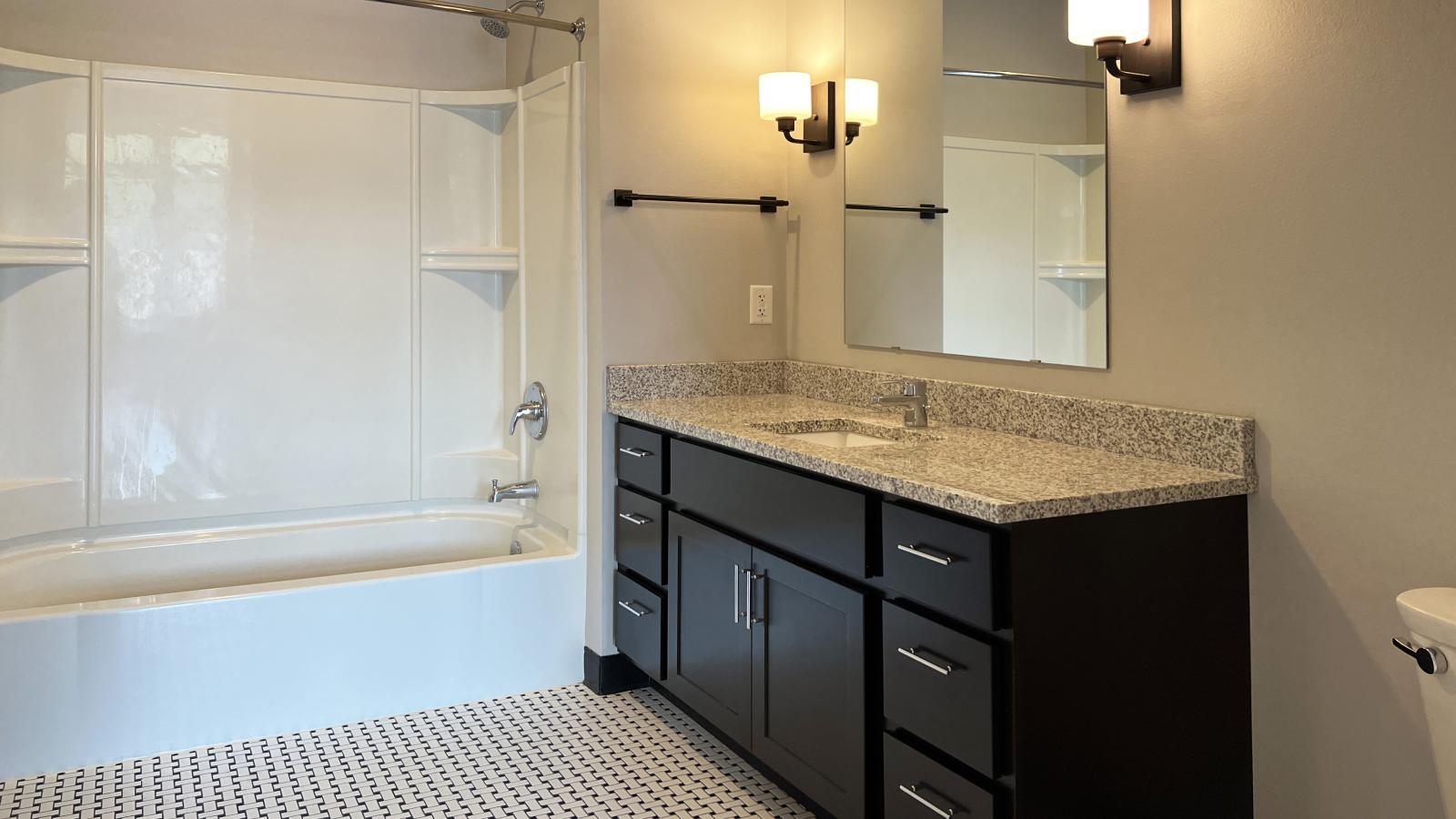 Modern one bedroom bathroom at 1722 Monroe Apartments in Madison with classic tile and laundry