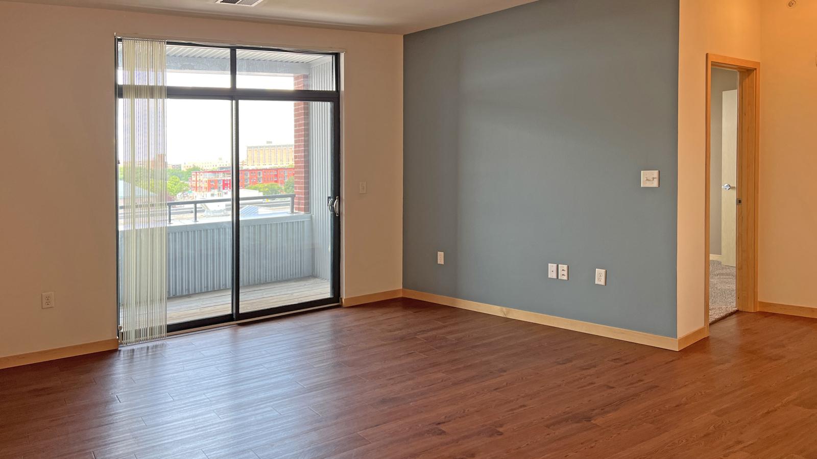 One bedroom apartment with a cozy living area and direct balcony access at The Depot in downtown Madison