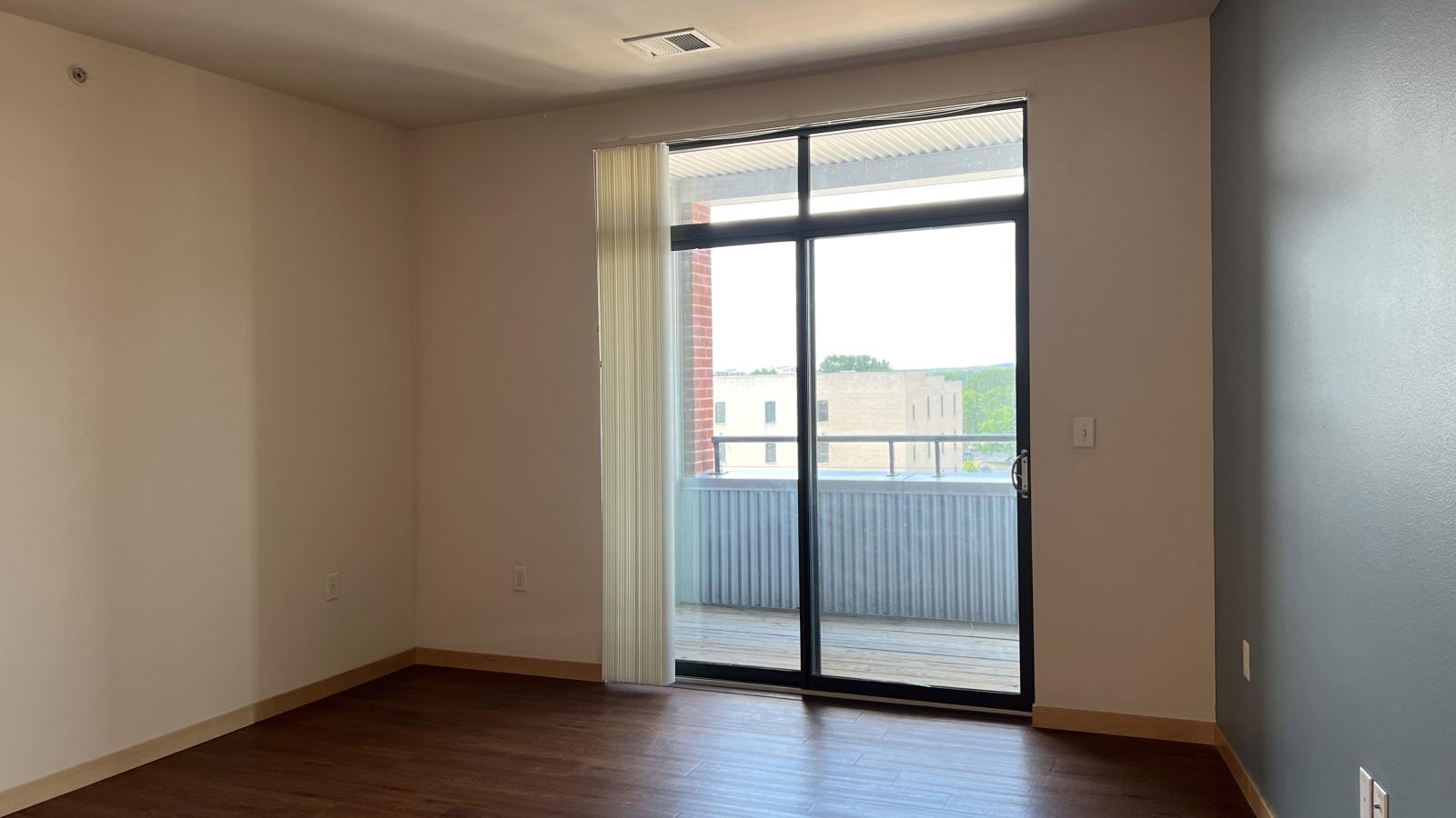 One bedroom apartment with a cozy living area and direct balcony access at The Depot in downtown Madison