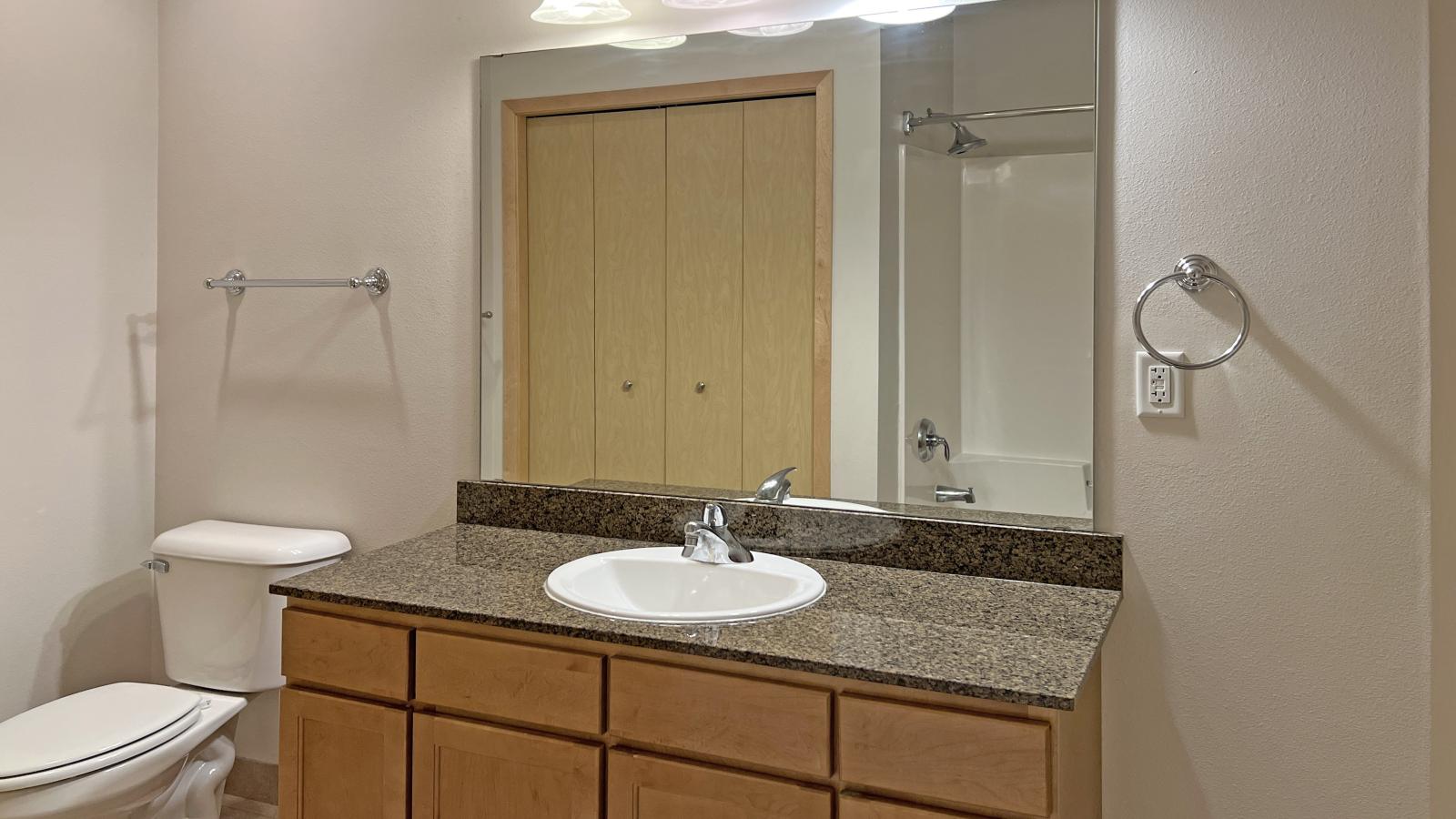 One bedroom apartment with granite bathroom counter at The Depot in downtown Madison