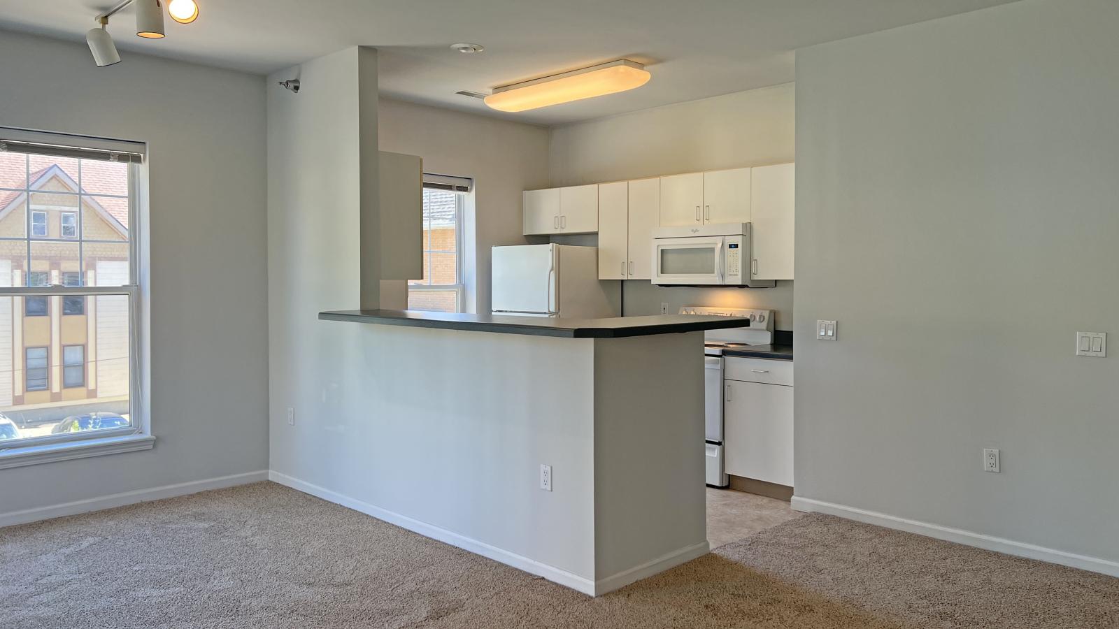 Bright kitchen with standard appliances and cabinetry at City Place Apartments