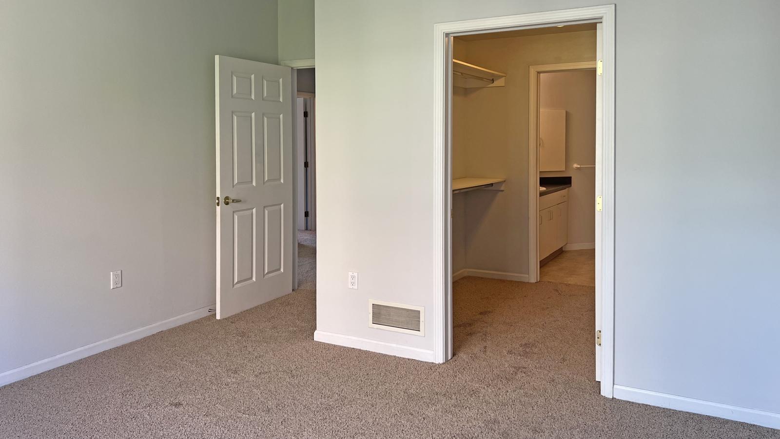 Bright bedroom with large windows, ample closet space, and attached bathroom at City Place