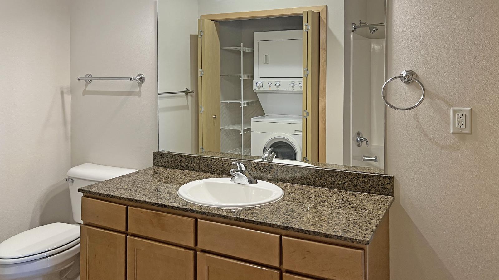 One bedroom apartment with granite bathroom counter at The Depot in downtown Madison