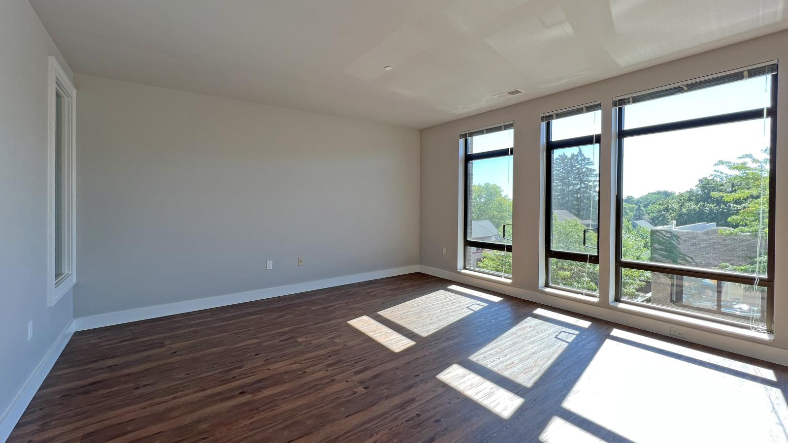 Bright living spcae in one bedroom apartments with wall of windows at 1722 Monroe in Madison