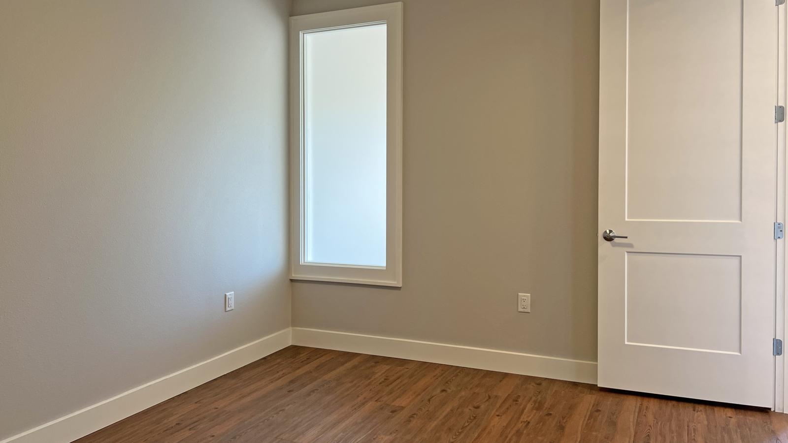 Bright and modern one-bedroom apartment at 1722 Monroe Apartments in Madison with transem window and classic finishes.