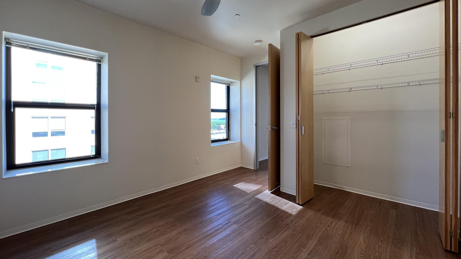 Spacious bedroom with ample storage and large windows at Capitol Hill Apartments