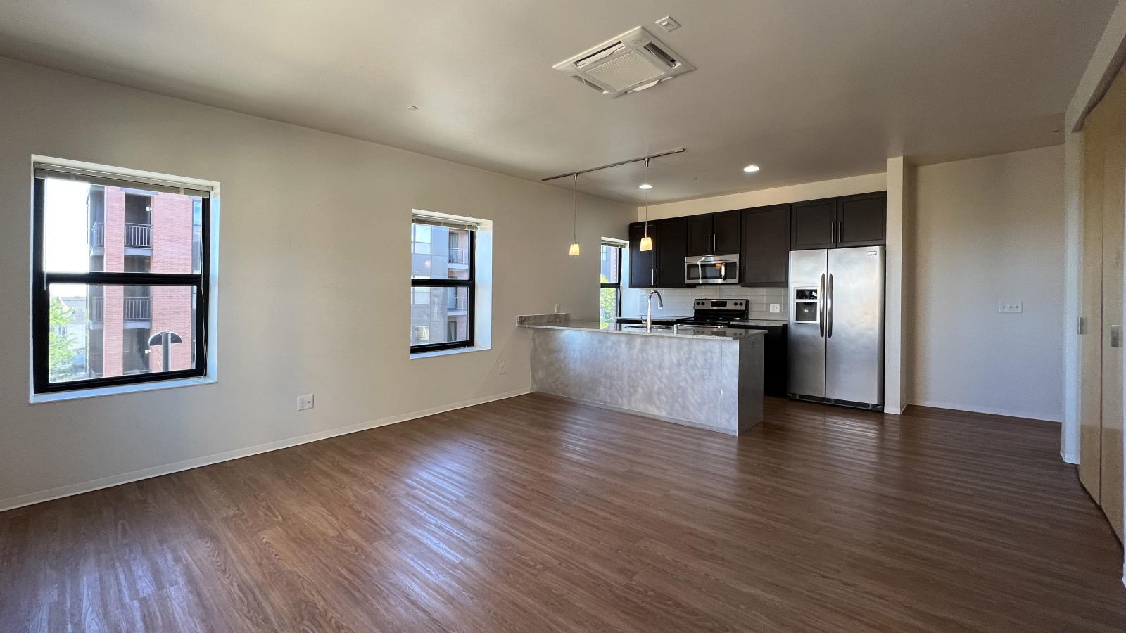 Kitchen with granite countertops, stainless steel appliances, and brushed aluminum backed island at Capitol Hill