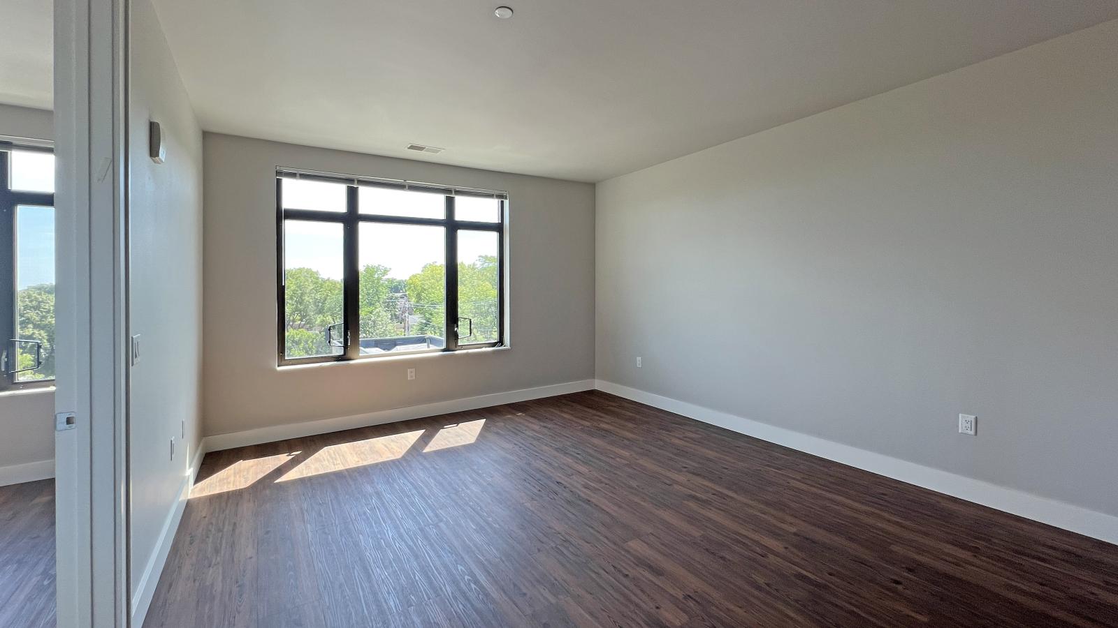 Spacious one-bedroom apartment at 1722 Monroe Apartments in Madison featuring large windows and an open floor plan.