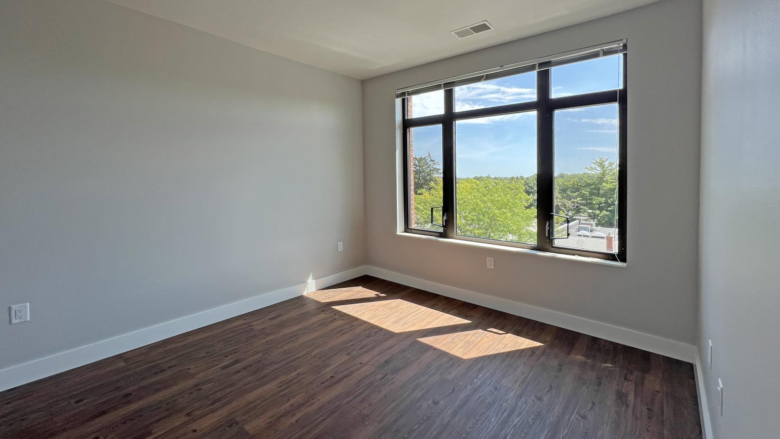 Sunny bedroom with solid flooring and soft finishes in one bedroom at 1722 Monroe Apartments in Madison