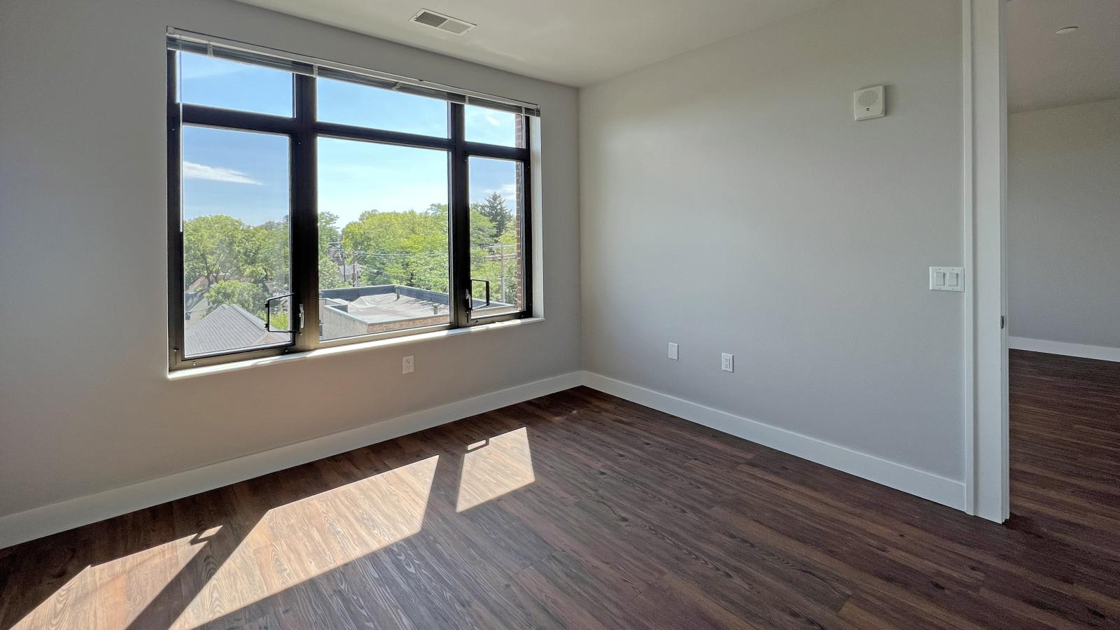 Sunny bedroom with solid flooring and soft finishes in one bedroom at 1722 Monroe Apartments in Madison