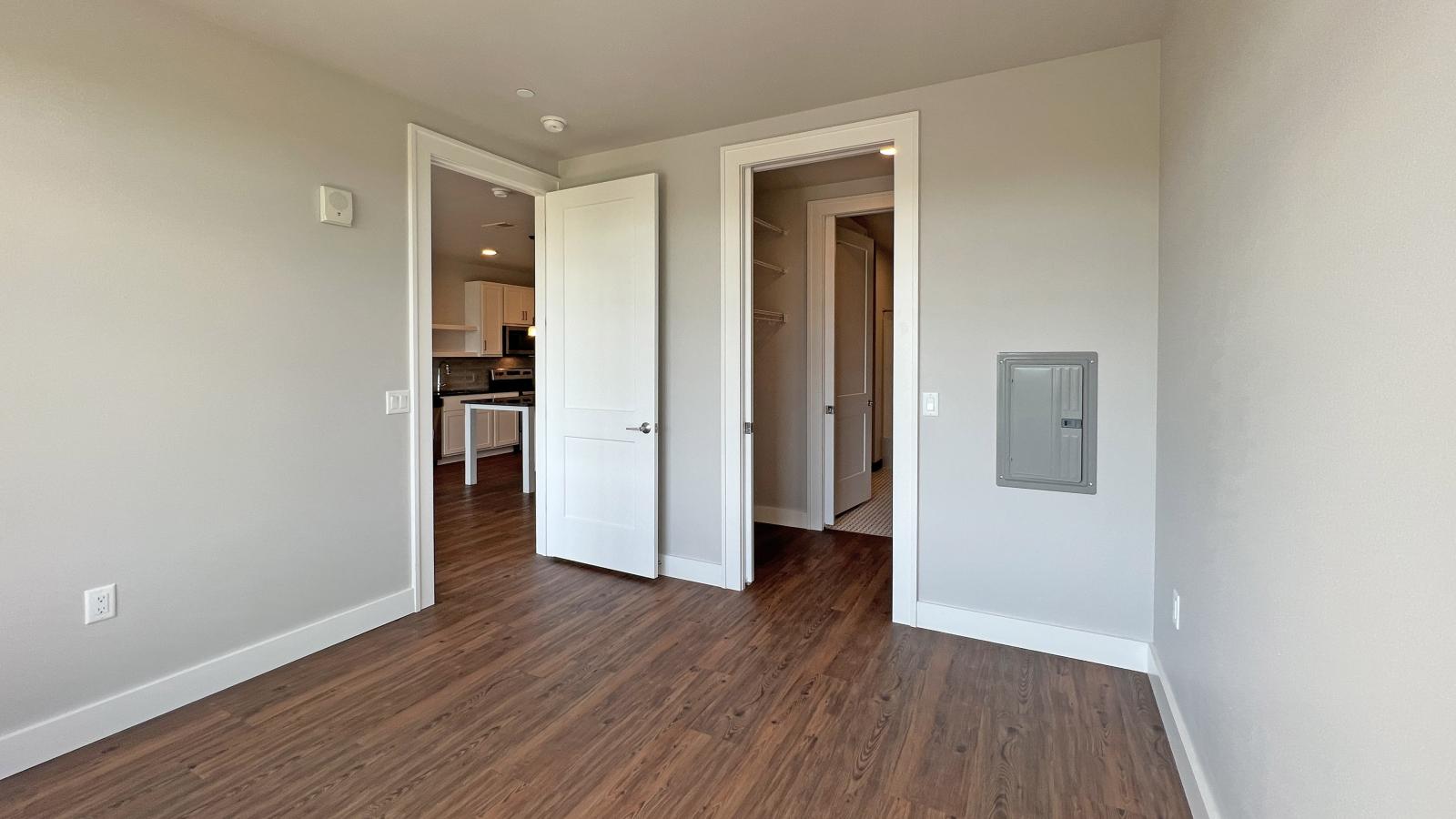 Sunny bedroom with solid flooring, walk in close, and soft finishes in one bedroom at 1722 Monroe Apartments in Madison