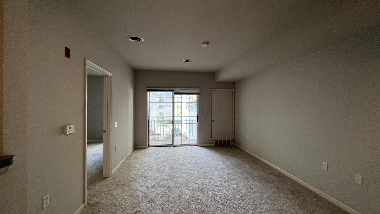 Cozy living room with soft finishes and private balcony at Wilson Bay