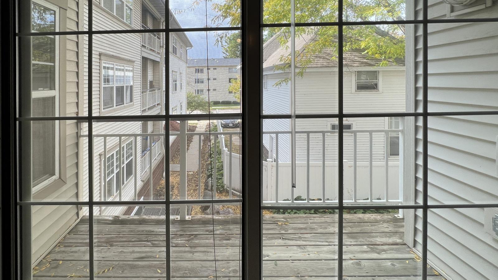 Private balcony offering neighborhood views in a one-bedroom at Wilson Bay