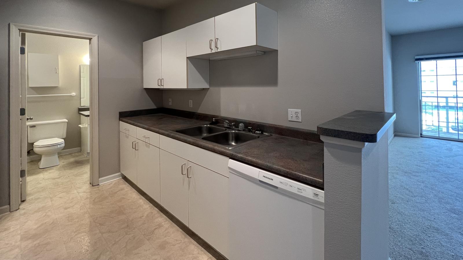 Kitchen with classic cabinetry and ample counter space in a one-bedroom at Wilson Bay