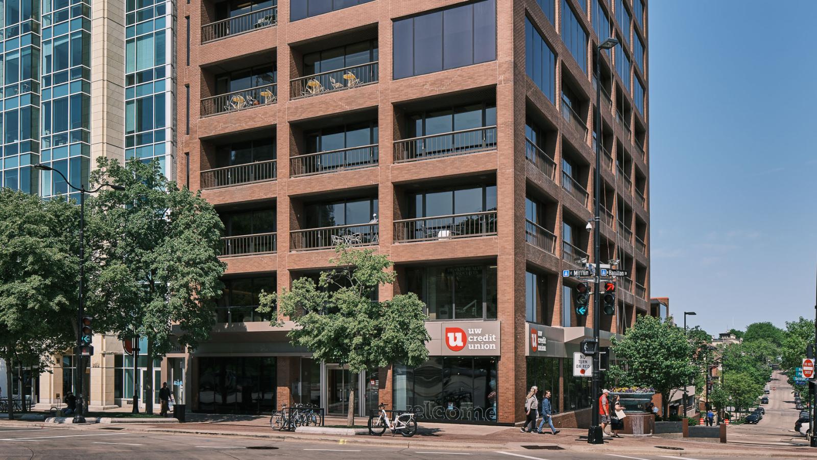 Modern glass and steel office building at 44 East Mifflin Street, featuring a sleek façade with floor-to-ceiling windows and a prominent Capitol Square location.