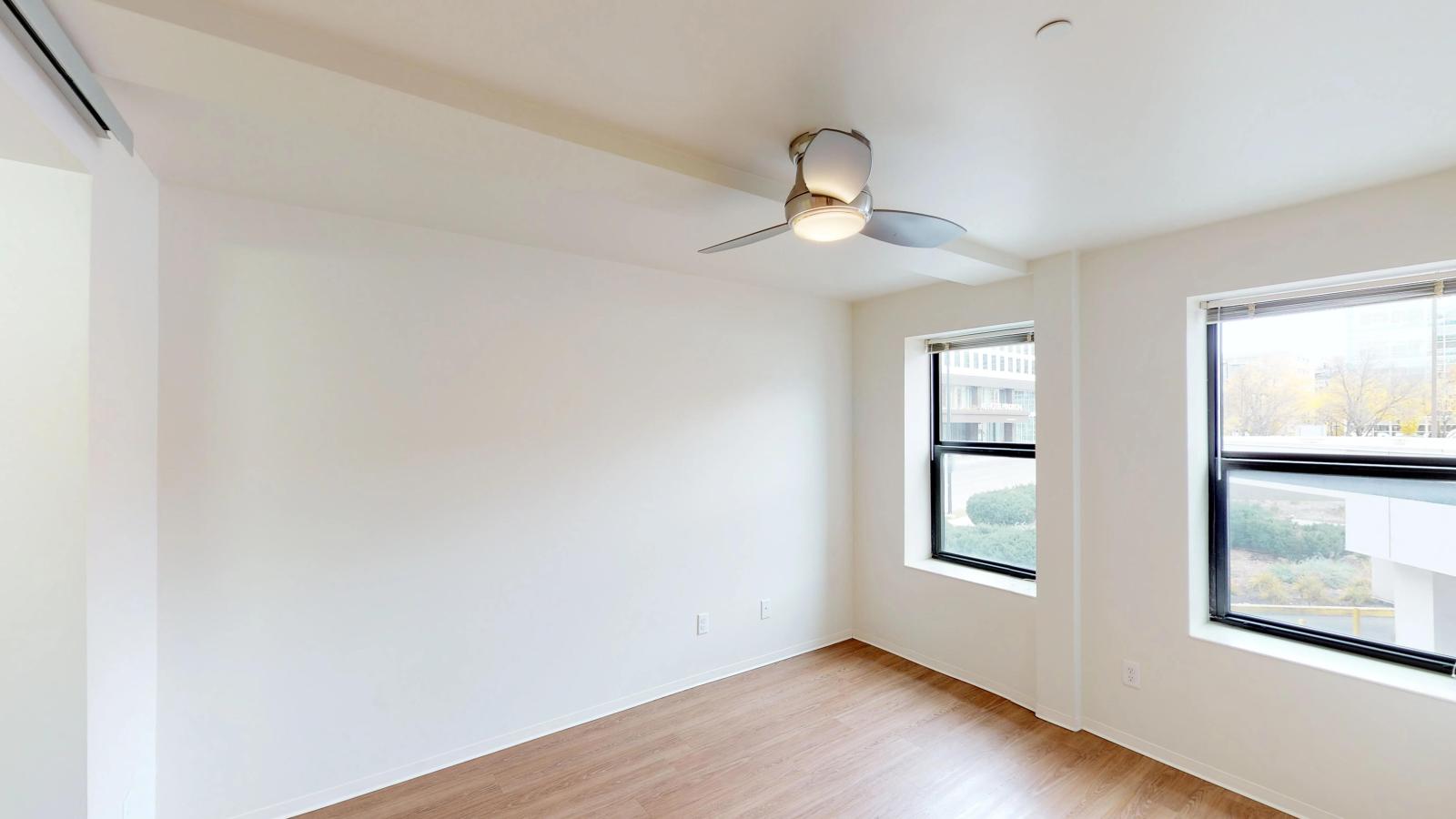 Spacious bedroom with ample storage and large windows at Capitol Hill Apartments