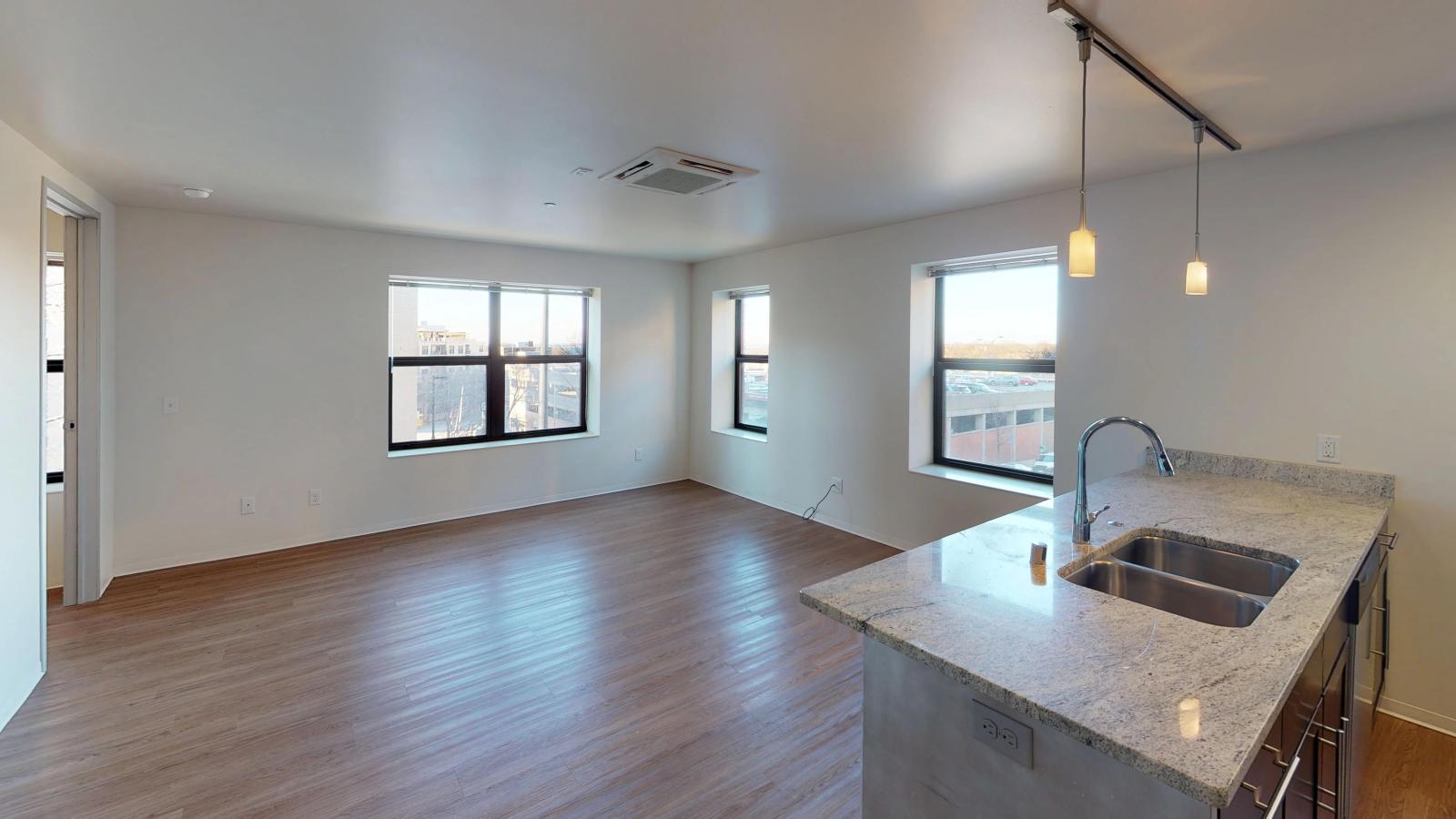 Living room with solid-surface and stunning natural light at Capitol Hill Apartments