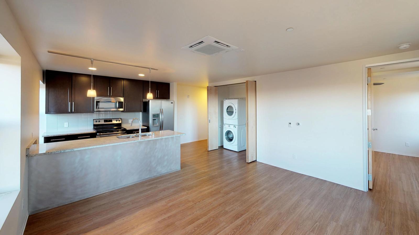 Kitchen with granite countertops, stainless steel appliances, and brushed aluminum backed island at Capitol Hill