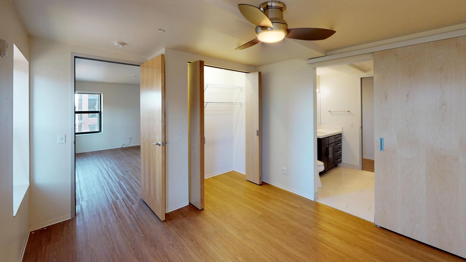 Spacious bedroom with ample storage and large windows at Capitol Hill Apartments