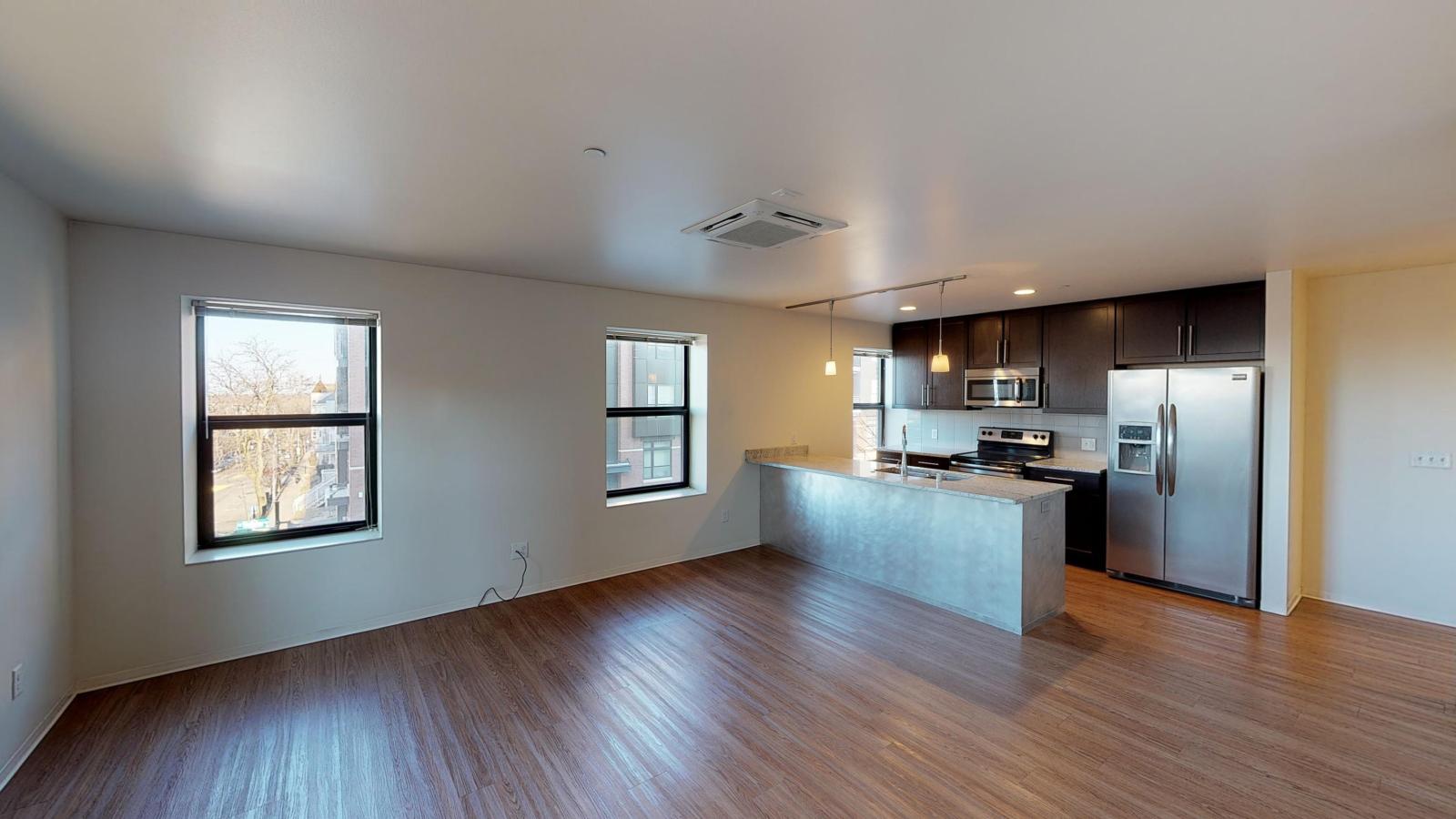 Kitchen with granite countertops, stainless steel appliances, and brushed aluminum backed island at Capitol Hill