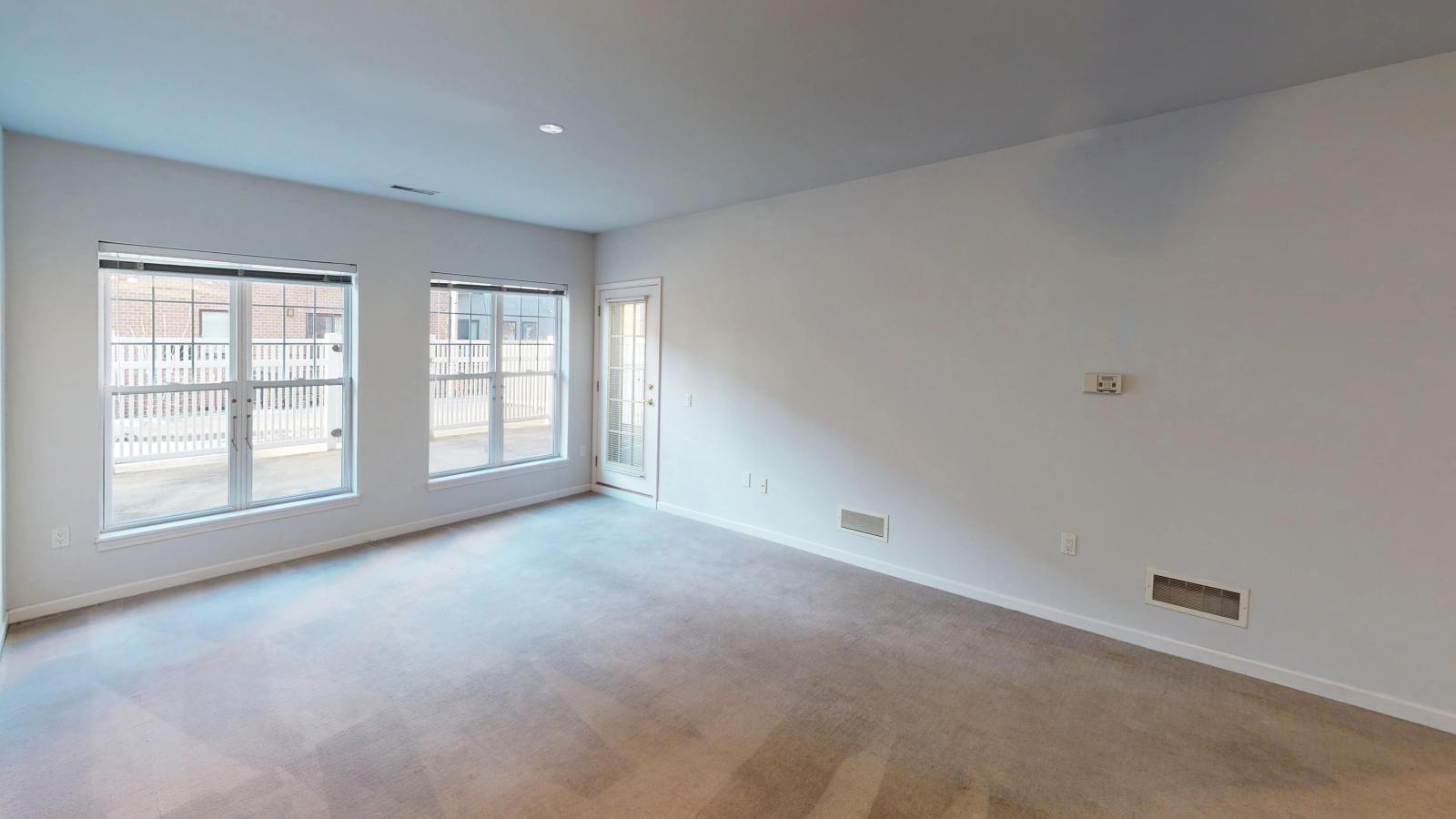 Living room with large windows and natural light in a one-bedroom apartment at City Place