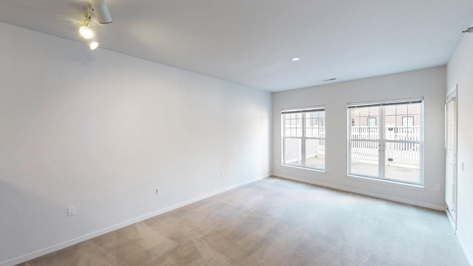 Living room with large windows and natural light in a one-bedroom apartment at City Place