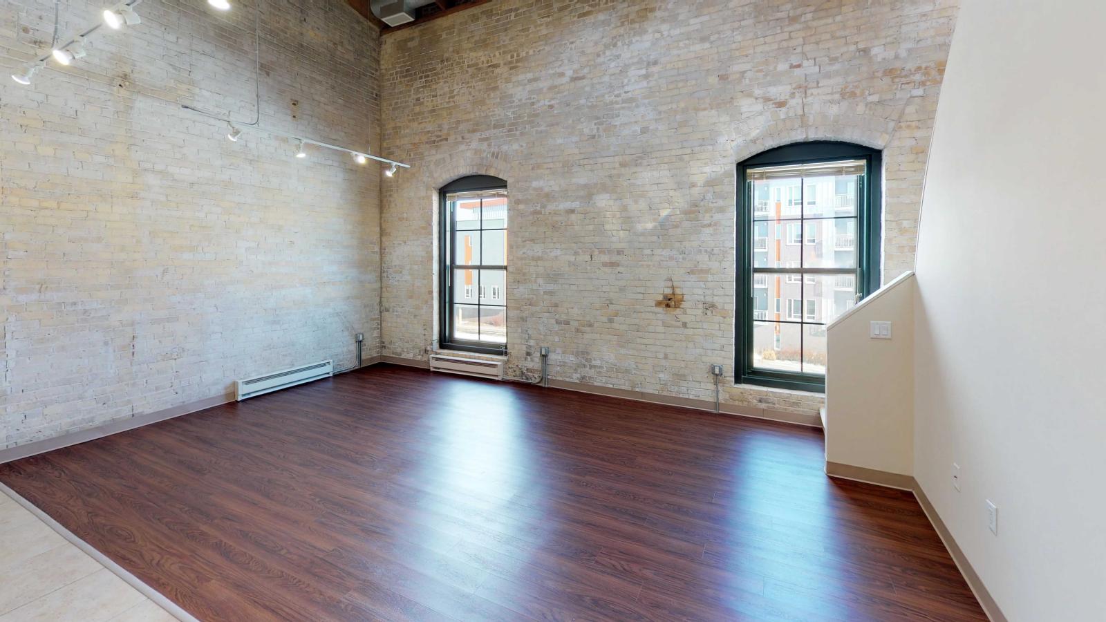 Two bedroom loft featuring large windows high ceilings at Tobacco Lofts
