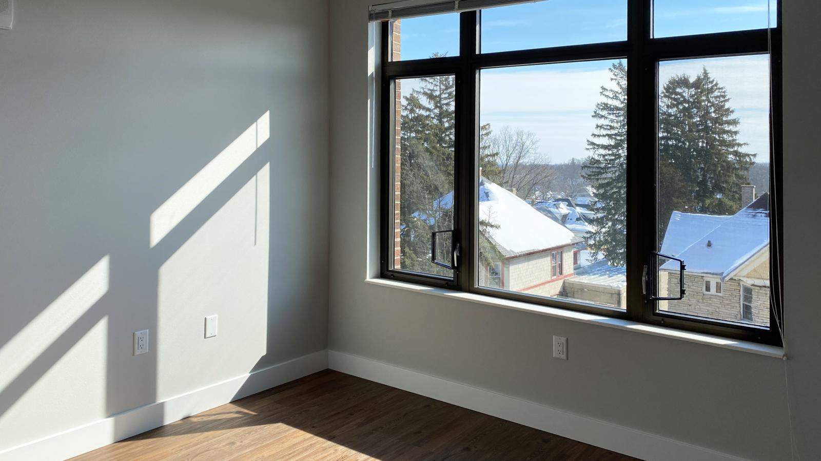 Spacious one-bedroom apartment at 1722 Monroe Apartments in Madison featuring large windows and an open floor plan.