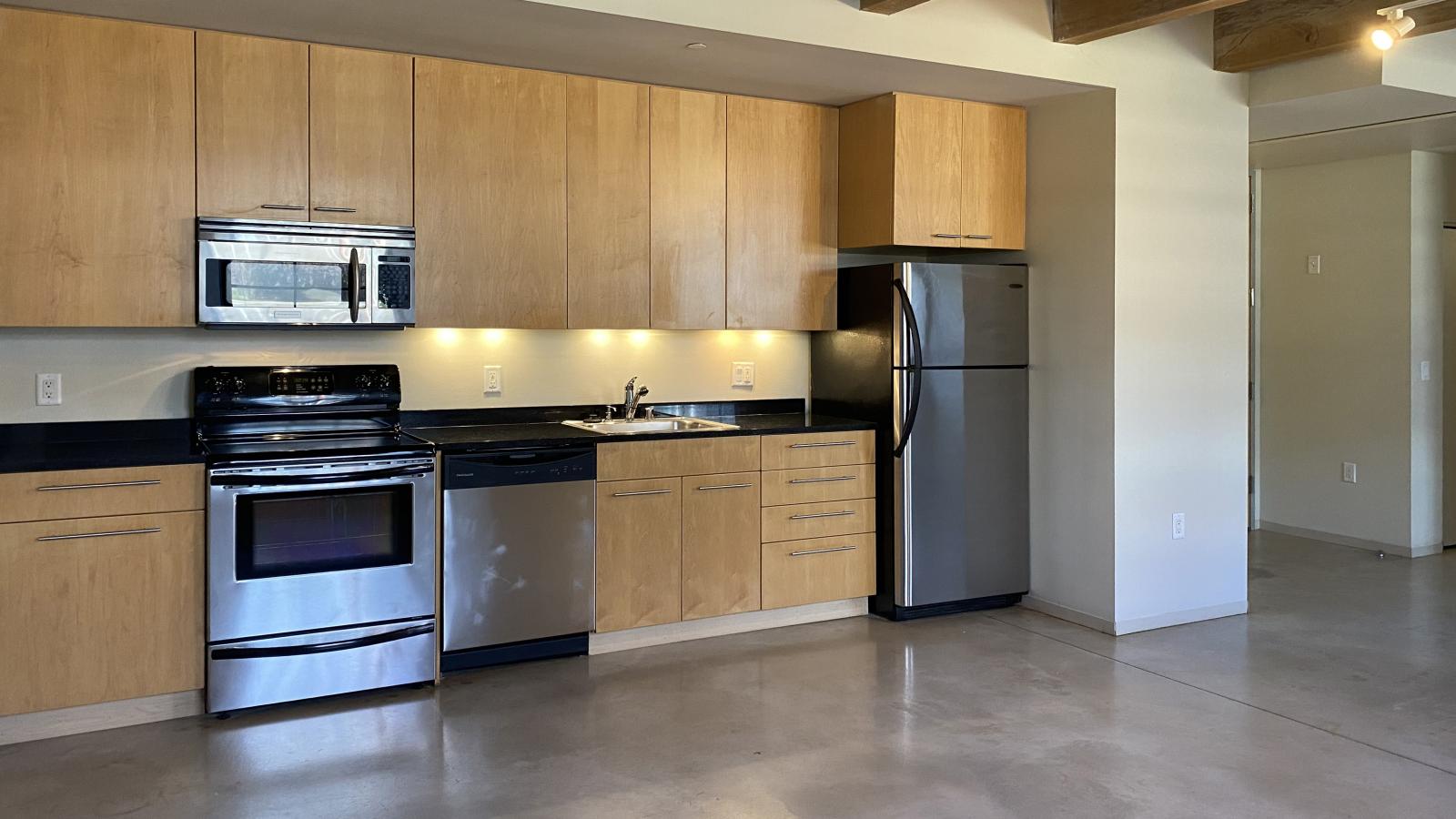 Spacious one bedroom with polished concrete floors, modern appliances, and historic charm at Tobacco Lofts