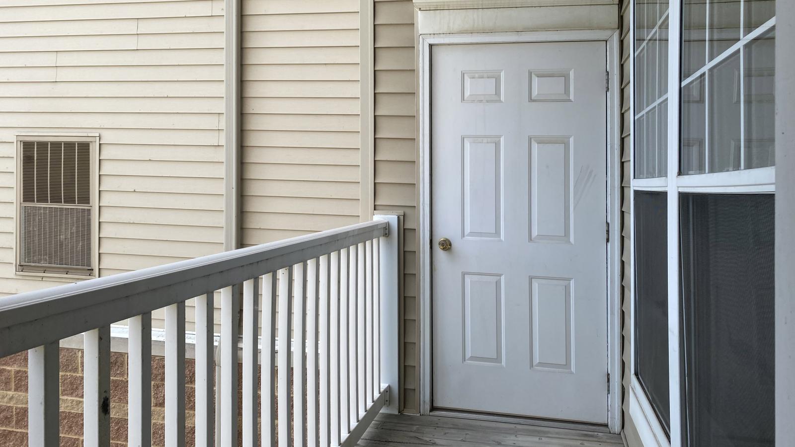 Private balcony with tree-lined street views at City Place Apartments