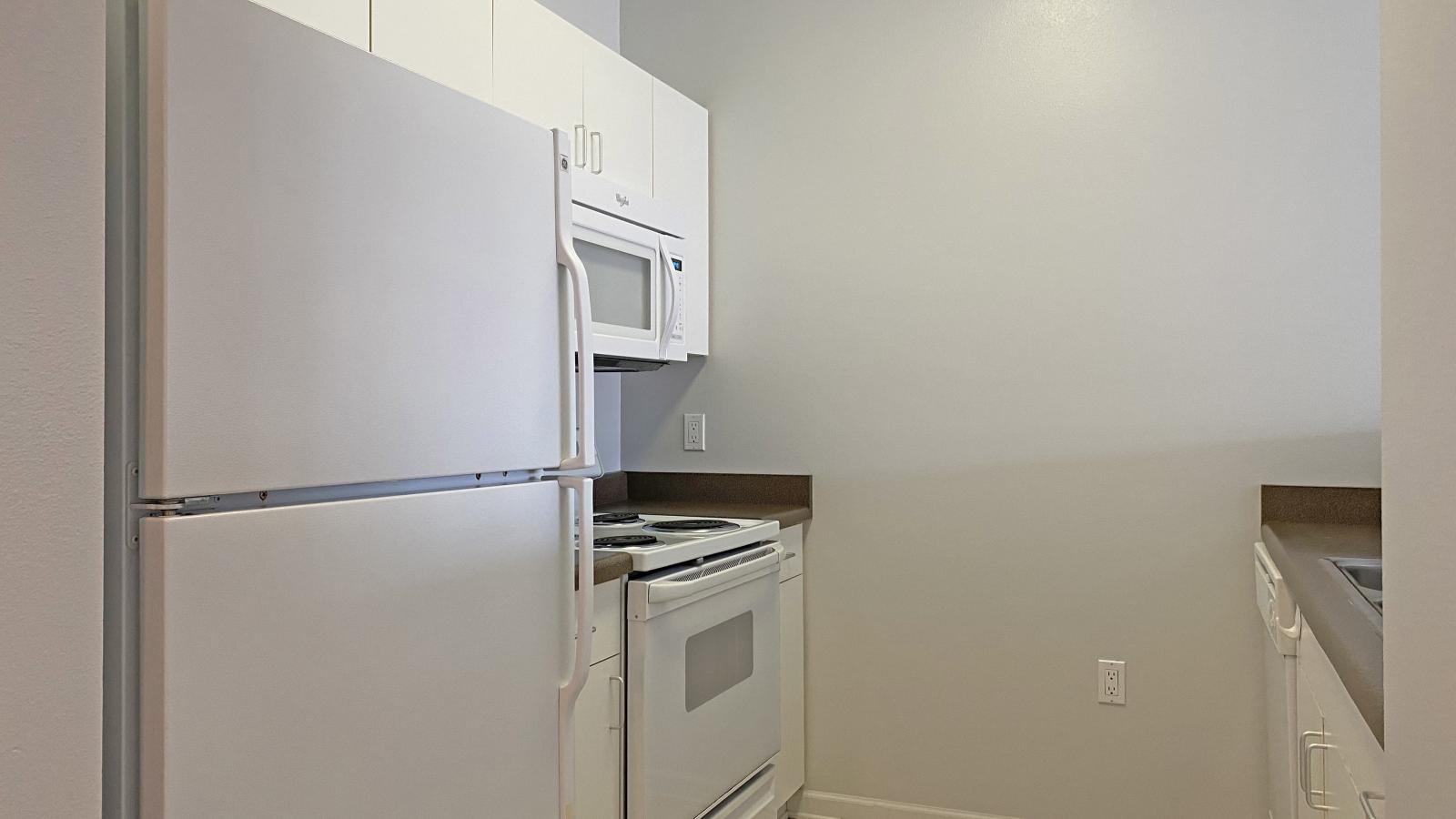 Kitchen with standard appliances and cabinetry at City Place Apartments