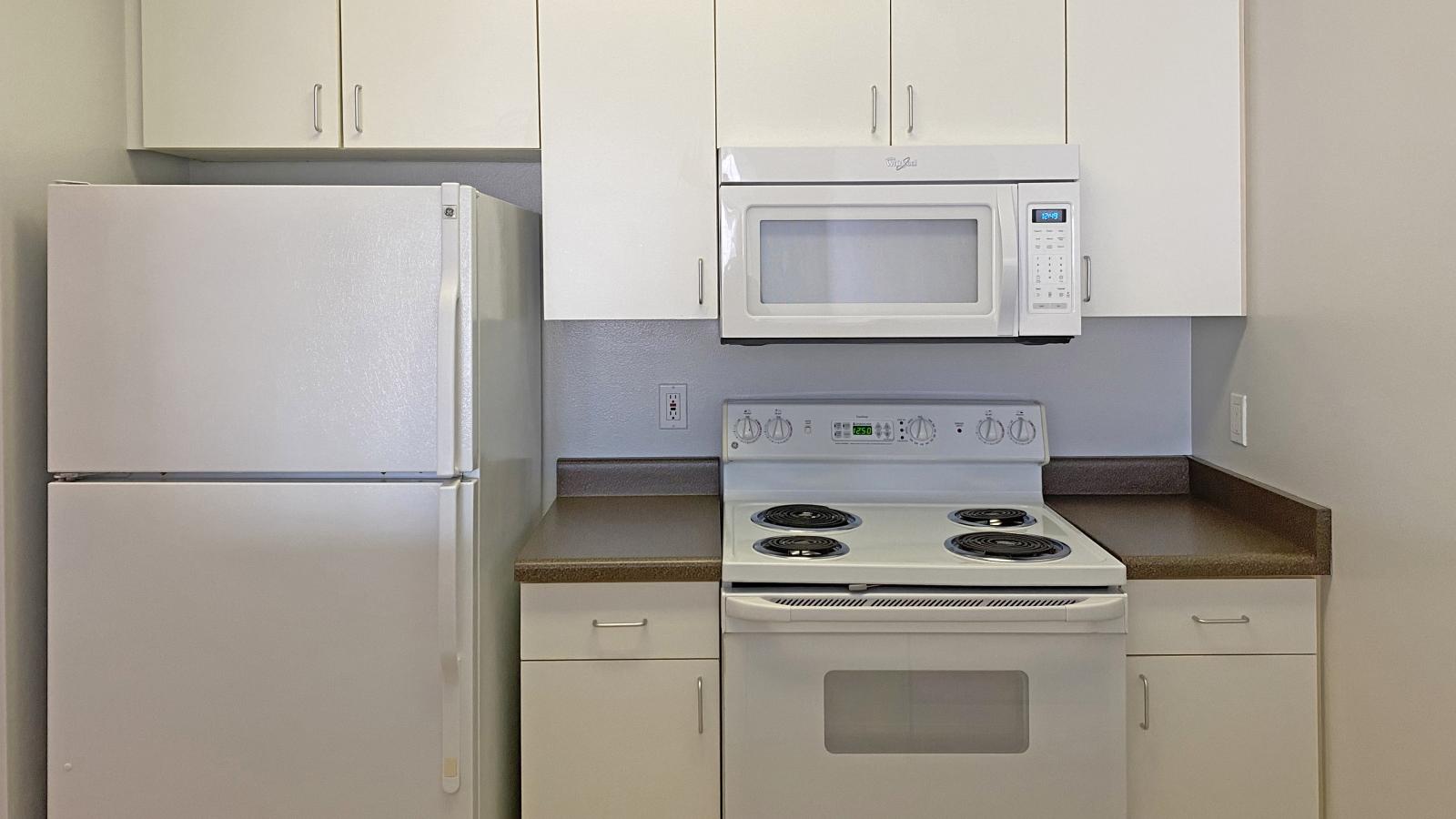 Kitchen with standard appliances and cabinetry at City Place Apartments