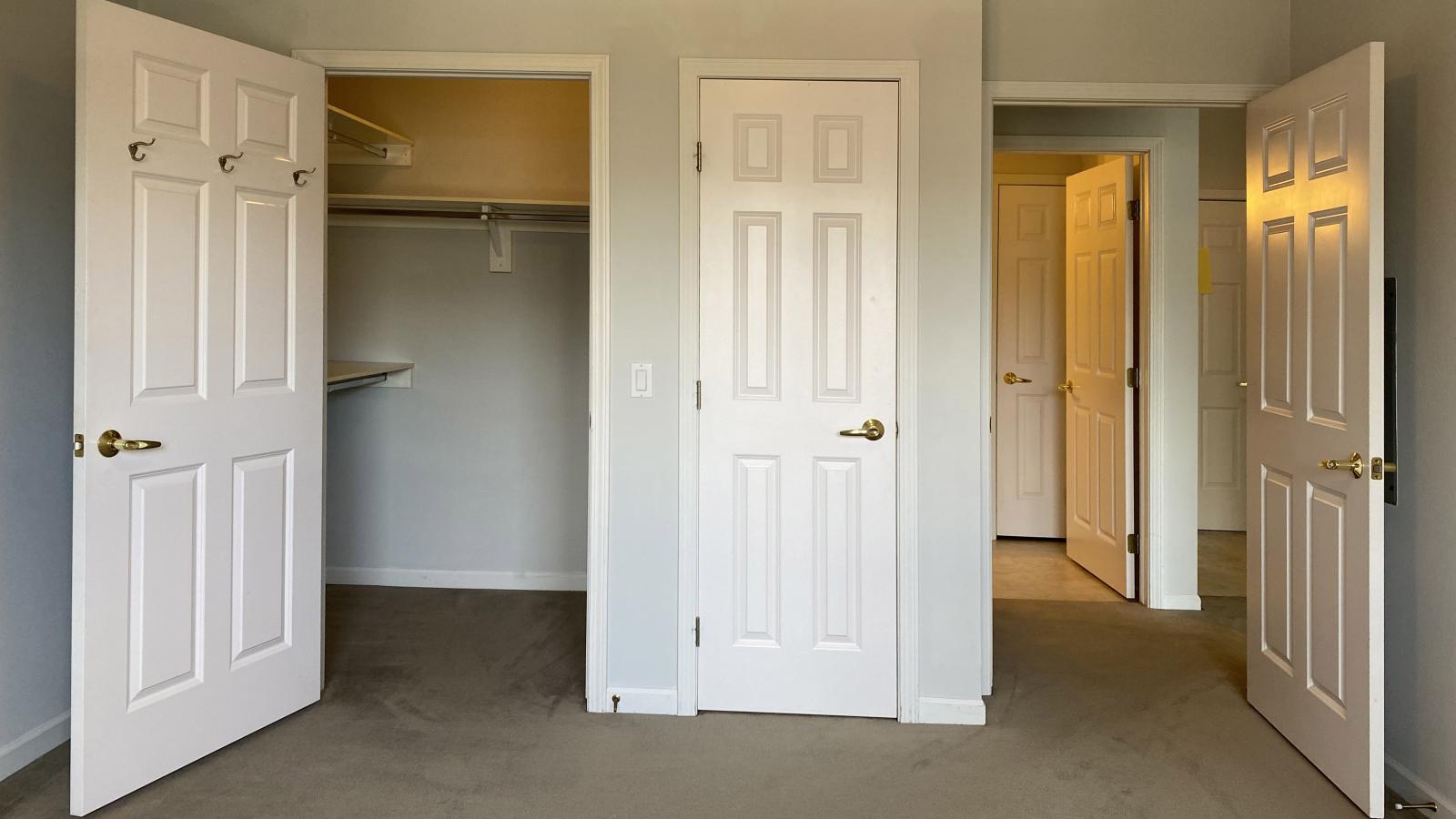 Bright bedroom with large windows, ample closet space, and soft finishes at City Place