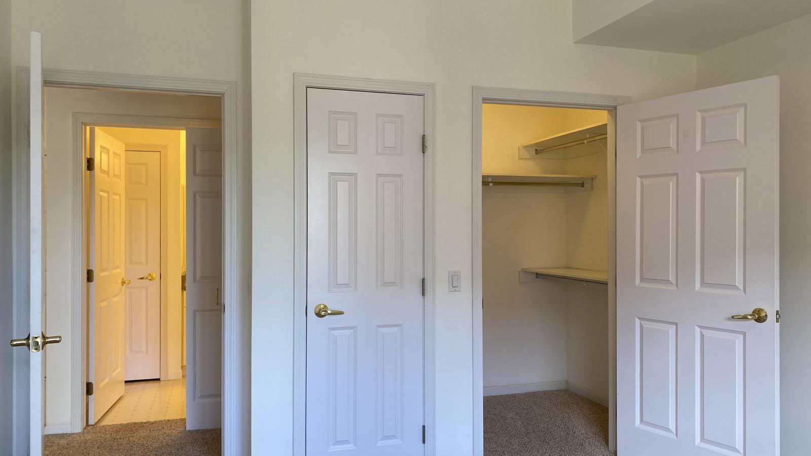 Bright bedroom with large windows, ample closet space, and soft finishes at City Place