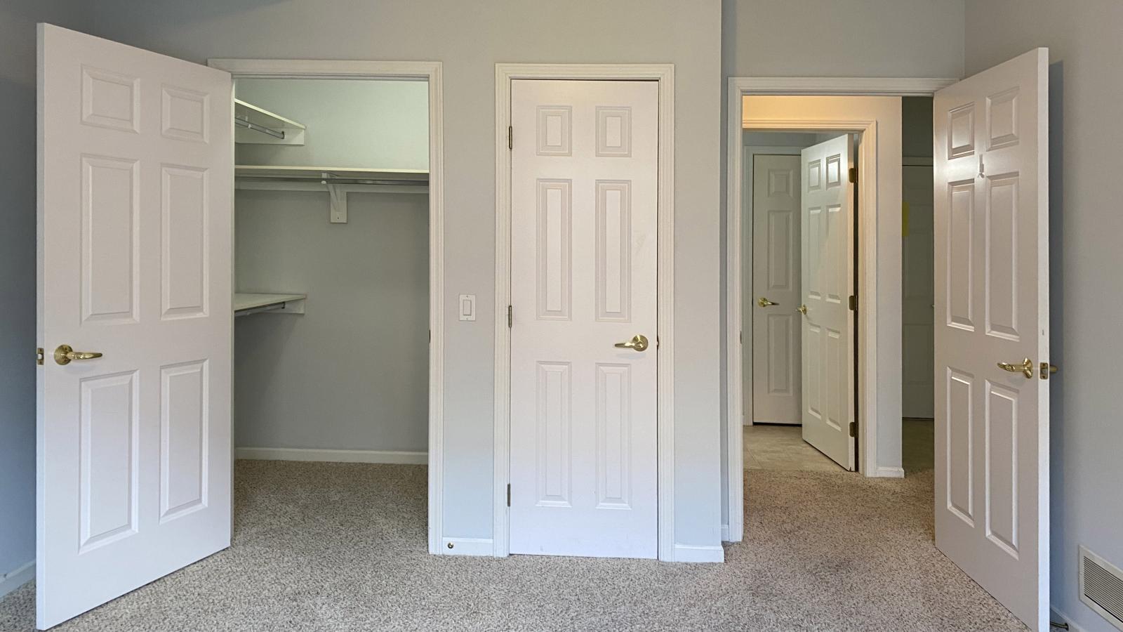 Bright bedroom with large windows, walk in closet and linen closet, and soft finishes at City Place