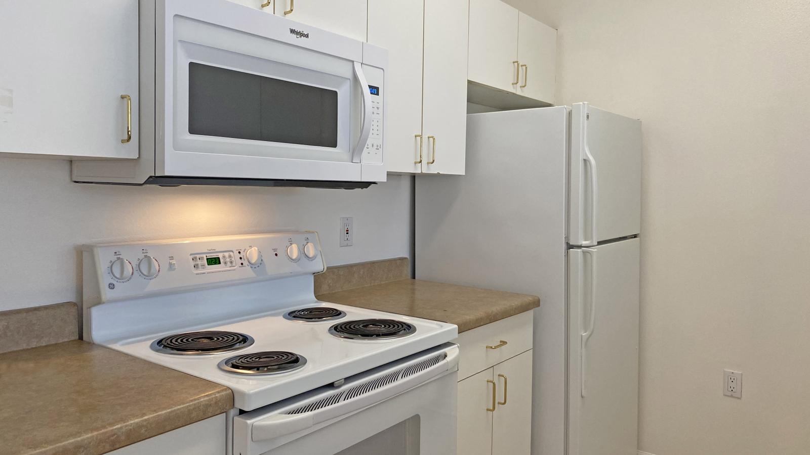Kitchen with standard appliances and cabinetry at City Place Apartments