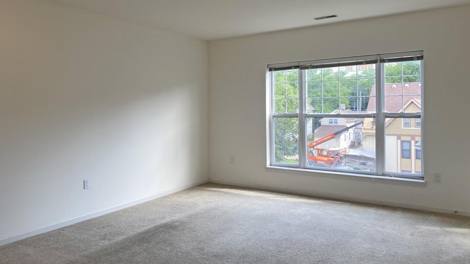 Living room with soft finishes and private balcony at City Place