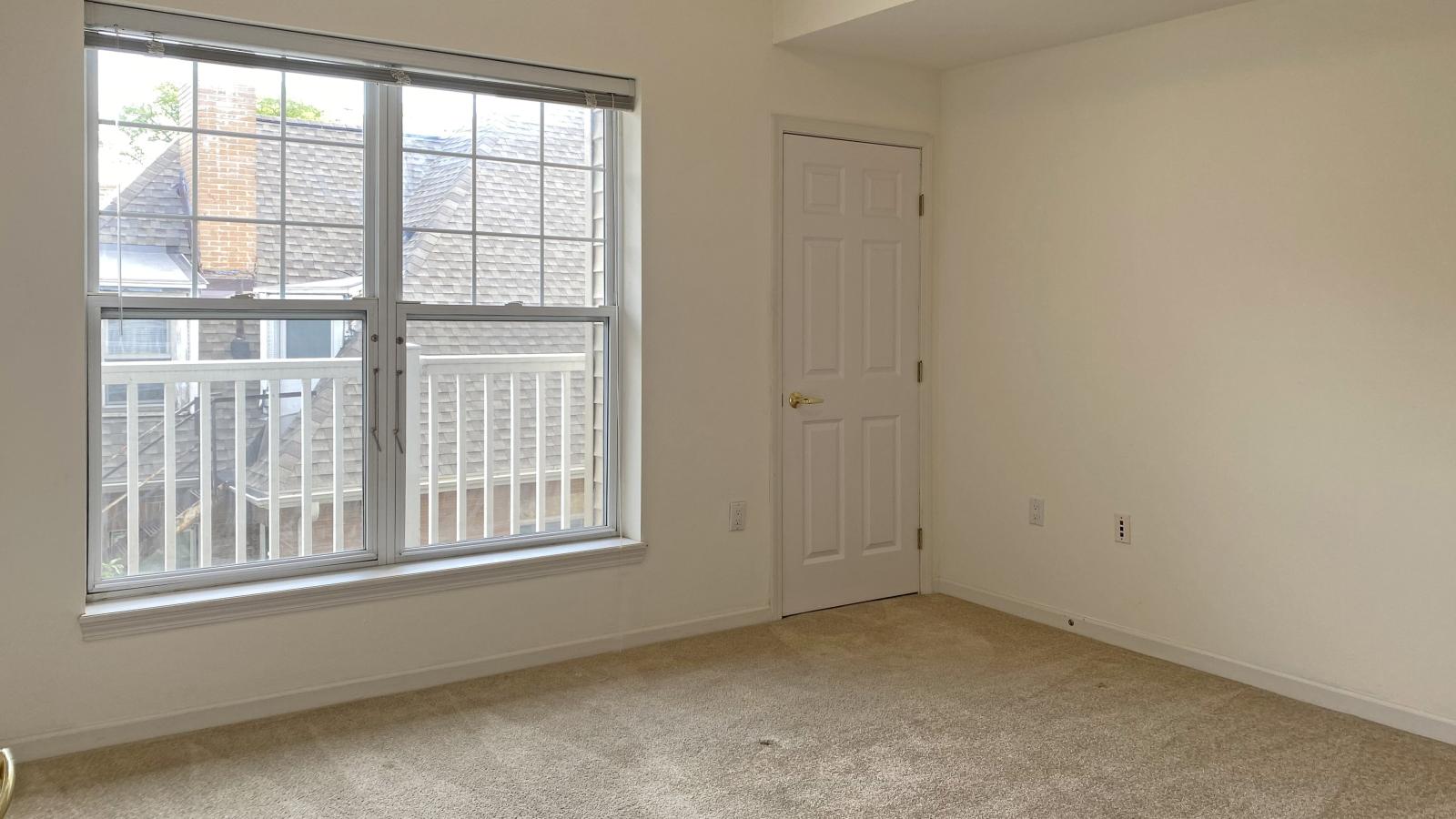 Bright bedroom with large windows, ample closet space, and attached bathroom at City Place