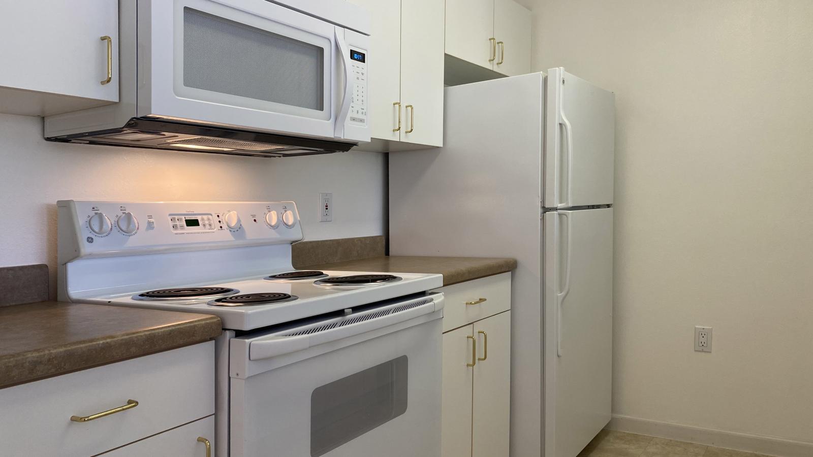 Kitchen with standard appliances and cabinetry at City Place Apartments